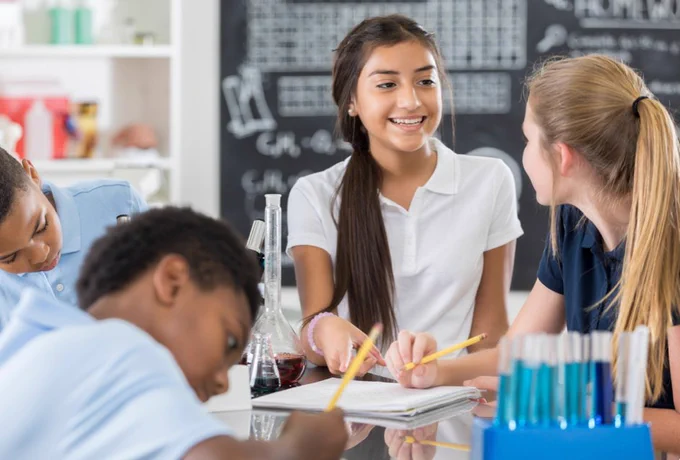 Image of middle school children doing a science experiment.