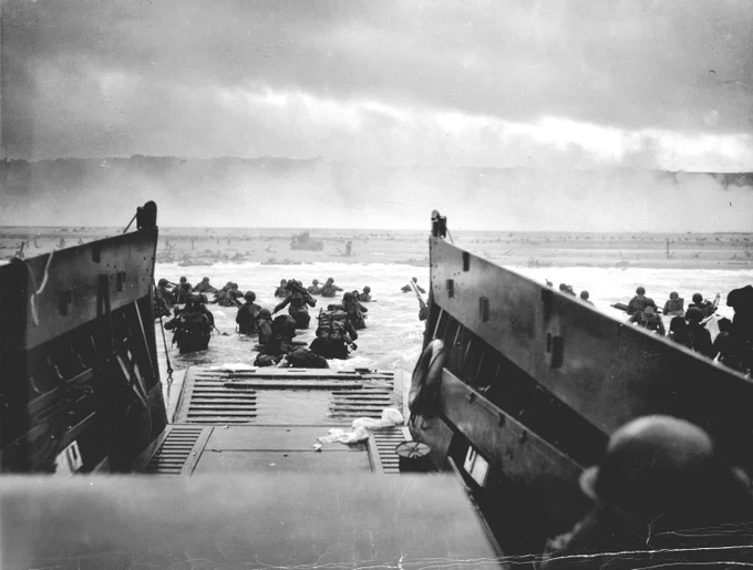 Assault landing, one of the first waves at Omaha. The Coast Guard caption identifies the unit as Company E, 16th Infantry, 1st Infantry Division. U.S. Coast Guard photo.