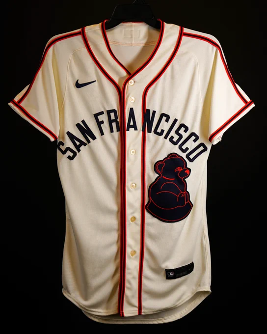  A throwback San Francisco Sea Lions jersey that the Giants will wear for the MLB at Rickwood game. The jersey is off-white with red piping, has San Francisco written in black letters across the front and a sea lion logo on the left side of the jersey.
