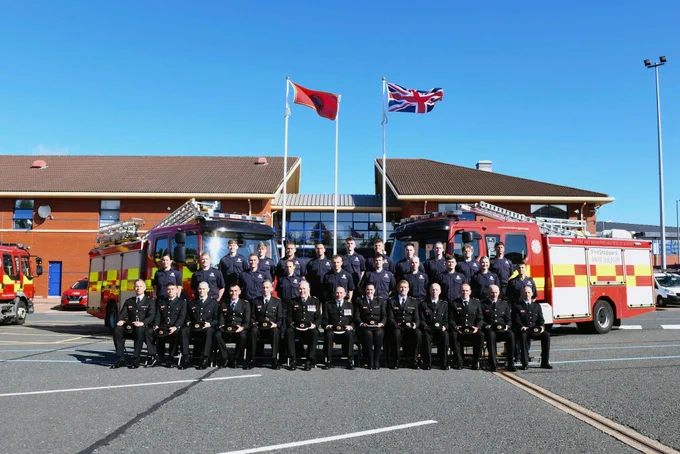 Group photograph featuring the firefighters from course 58.24 pictured on the training ground at service headquarters in Washington. 