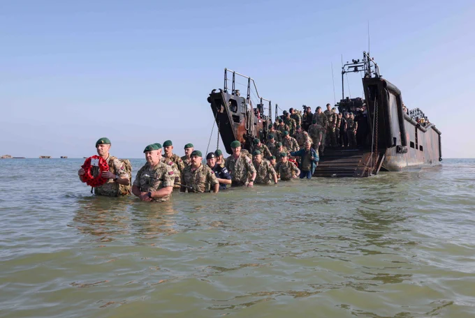 47 Commando Royal Marines make their way to the beach from a landing craft.