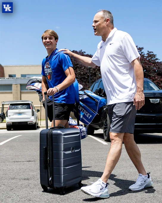 Travis Perry and Mark Fox walking in the parking lot. 