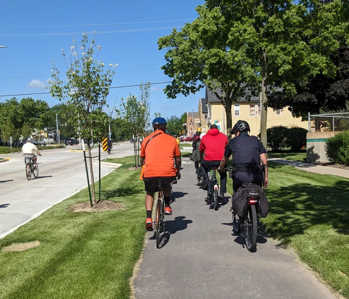 people riding bikes on protected bike lane