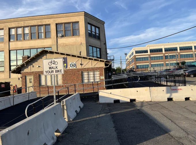  Non-permanent pedestrian ramp leading up to a multi-use path.