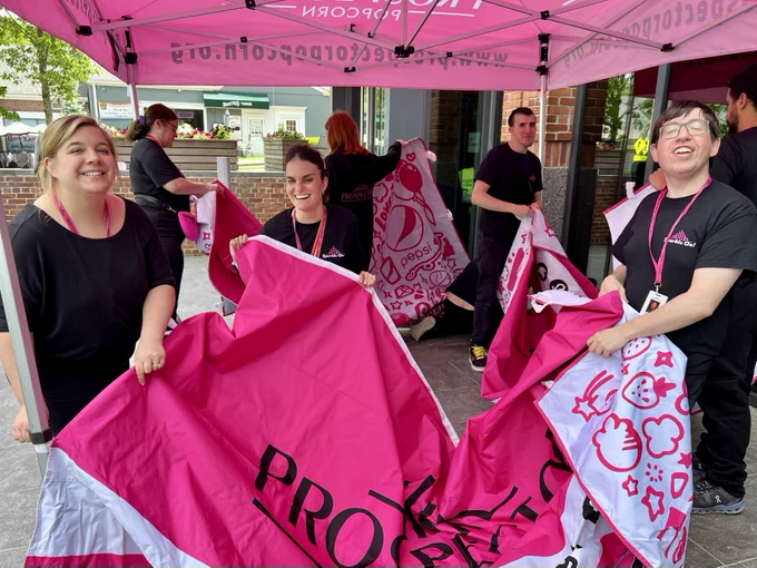 Prospects work together to set up the popcorn tent.