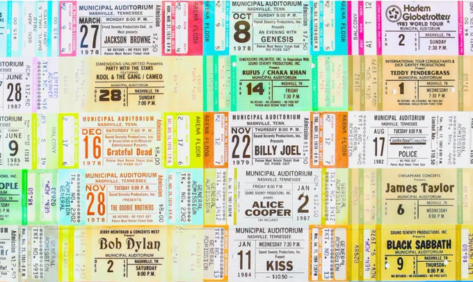 A top-down shot of a bunch of famous concert tickets lying next to each other.