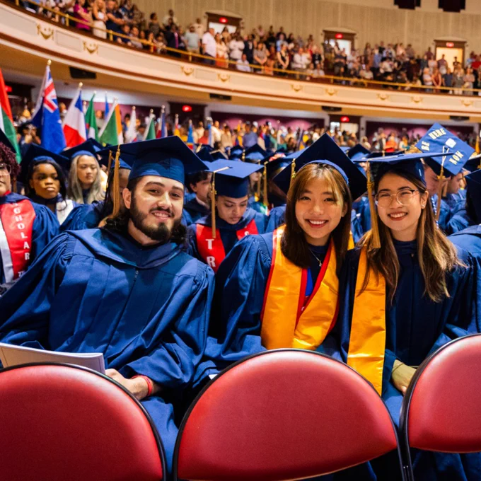 graduates sit in audience during ceremony