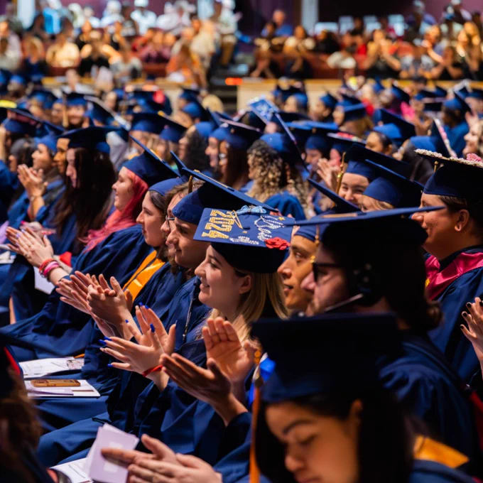 graduates sit in audience during ceremony
