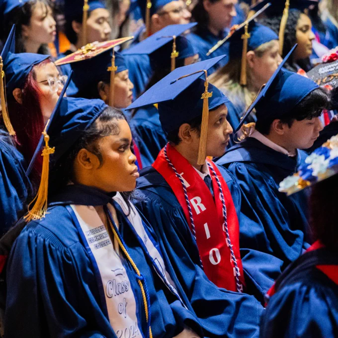 graduates sit in audience during ceremony