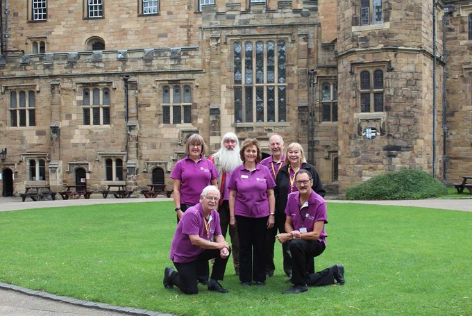 Colour photograph of seven of our fabulous team of volunteers taken in the Durham Castle courtyard
