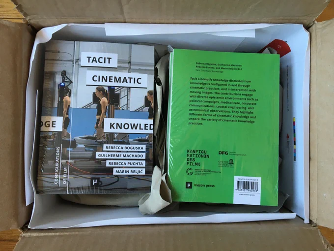 A box full of printed copies of the book Tacit Cinematic Knowledge