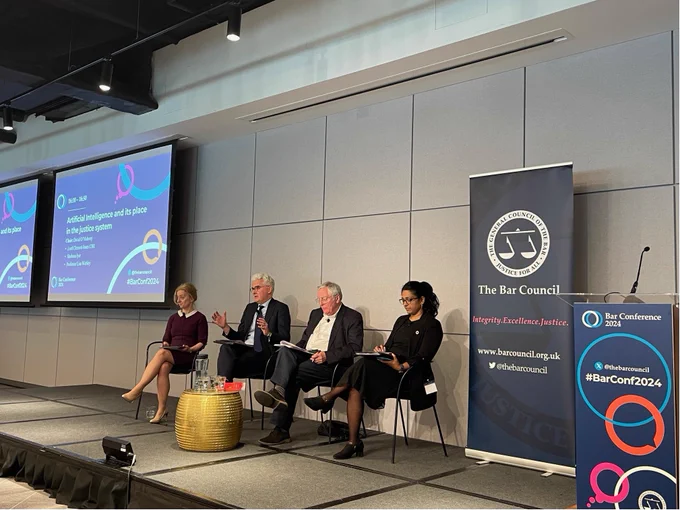 A panel of speakers sitting on a stage with Bar Conference 2024 branding. The speakers are: Lisa Webley, David O'Mahony, Lord Clement-Jones and Shobana Iyer