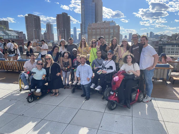 Photo description:
 Photo 1:
A group of Easterseals Disability Film Challenge stand together on a rooftop at the Tribeca Film Festival