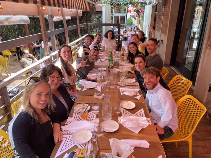 Photo 2:
A group of Easterseals Disability Film Challenge sit together at a table in an outside patio  at a Turkish restaurant