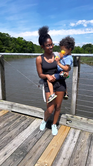 My toddler and I on a bridge above the river smiling
