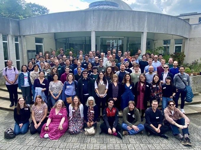 Photo with lots of people (staff and students from the BSU) in rows, all looking at the camera and smiling.  