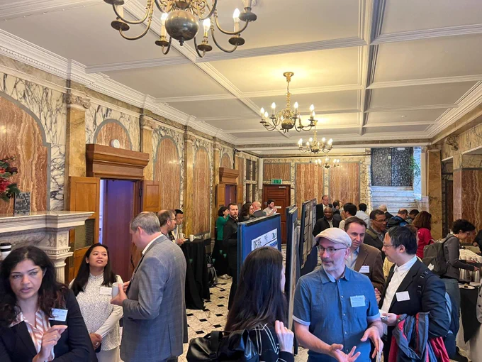 A picture of the foyer of the DENexus event, where people are milling about. 