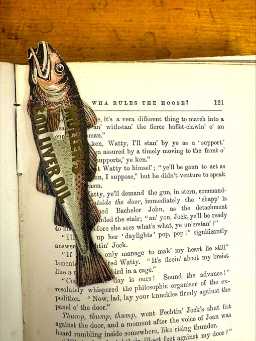 Full view of the fish shaped bookmark. Antique coloured paper book page marker advertising Cod liver oil