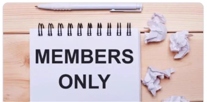 A note pad in white on a light wooden desk.  The words members only are written on it, a pen is lying neatly above it and some scrunched up note paper lies beside it 