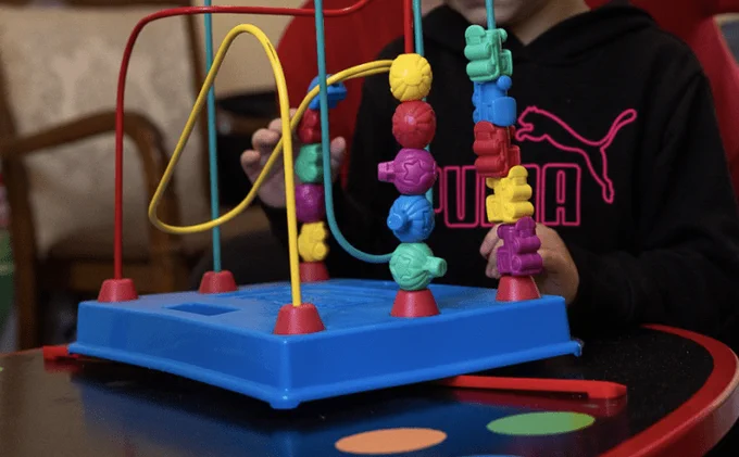 Girl playing with bright toy