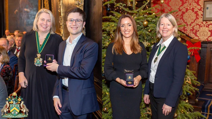 Dr Giovanni Montesano & Dr Cristine Martinez-Fernandez de la Camara receiving their awards from the Master Spectacle Maker. They are smartly dressed and smiling.