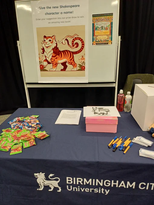 White board with a Tiger picture, and a desk with sweets and pens.