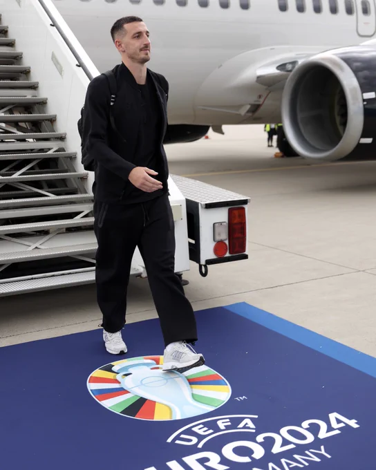 Lewis smiling while walking off the plane having landed in Germany. Our skipper!
