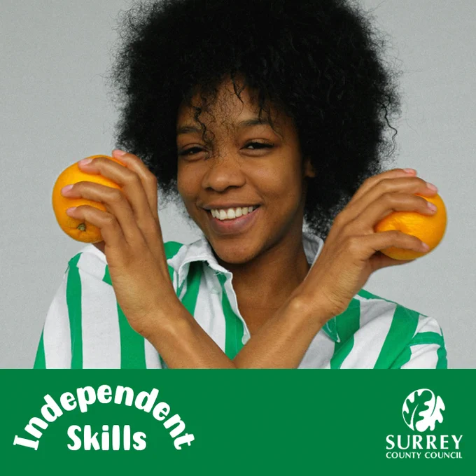 An image of a lady holding two oranges, smiling at the camera.
A green box along the bottom. The “Independent Skills” logo in the bottom left and the Oak Leaf Surrey County Council logo in the bottom right.