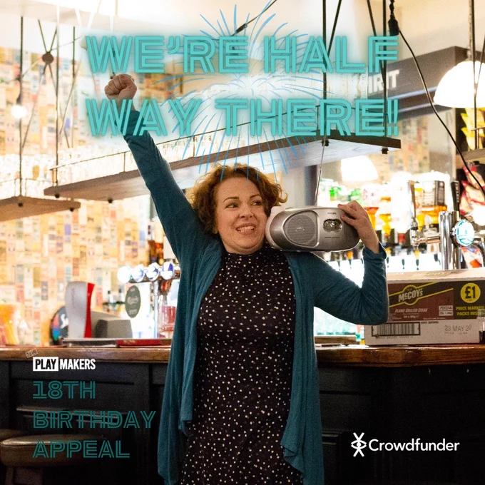 A production photo of an actress punching the air for joy holding a ghetto blaster in a pub. Text reads "We're half way there!"