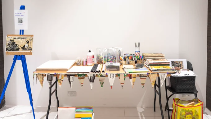 A creative workshop setup in a brightly lit white room. 