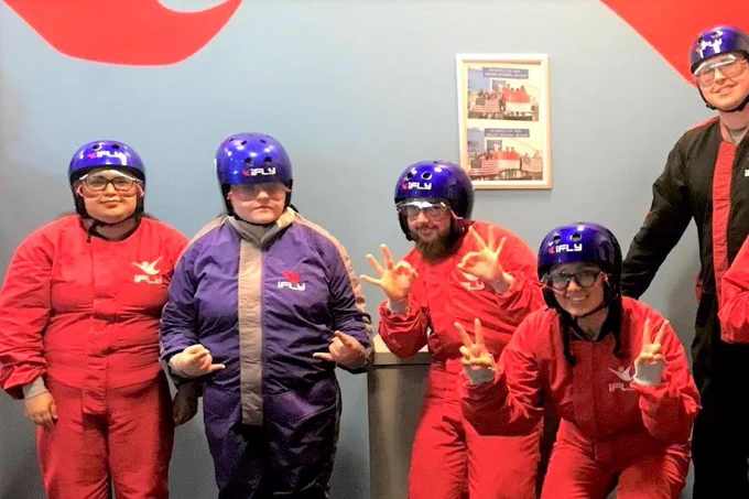 Picture of five young people in the Next Step program at Jackson Street Youth Services participating in indoor skydiving. (Photo courtesy of Jackson Street Youth Services.)