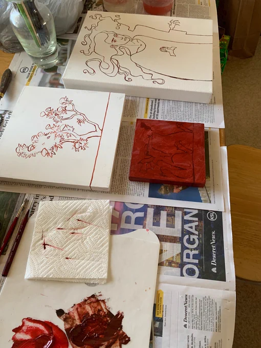 Three painting surfaces that have been gessoed and have their base drawings in red paint.