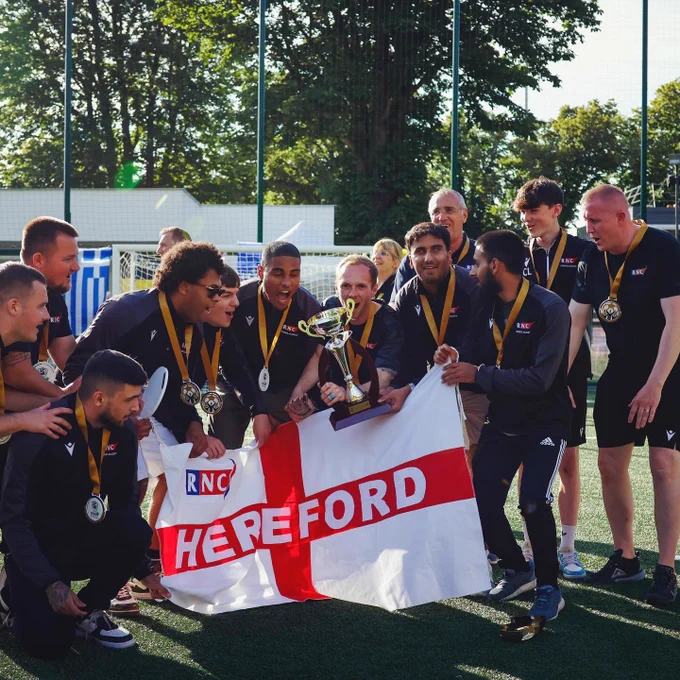 RNC players and staff lifting the trophy 🏆