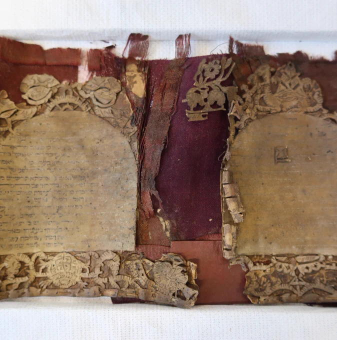 A small sample of toned Japanese paper being compared to the original silk colour