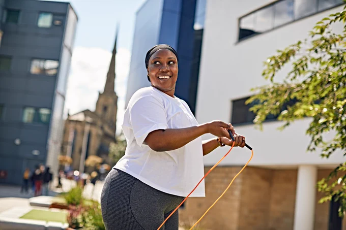 Person exercising outside with skipping rope