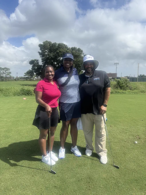 Group of 3 smiling on golf course greens