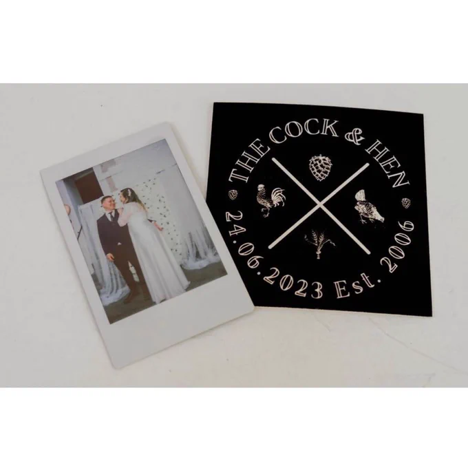 A photo of a Polaroid with me and Josh on our wedding day last year and our custom beer mat