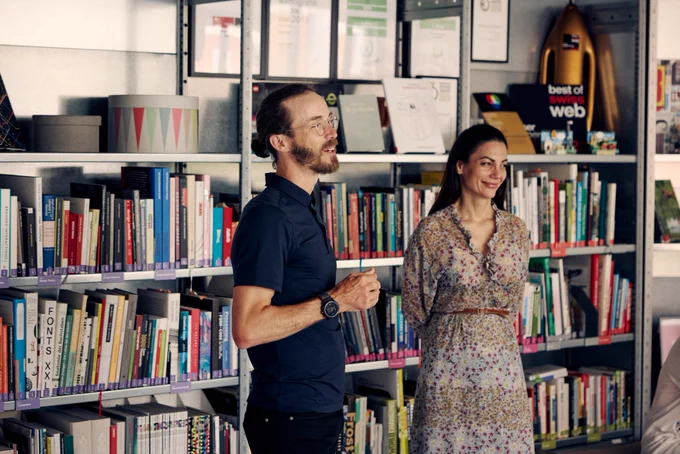 Our team members Benji and Ira standing in from of our library engaging with the rest of our team (not pictured).