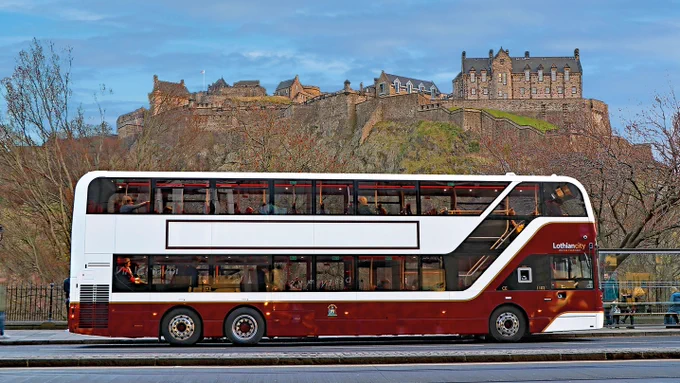 A Lothian city bus on Princes Street in front of Edinburgh Castle.
