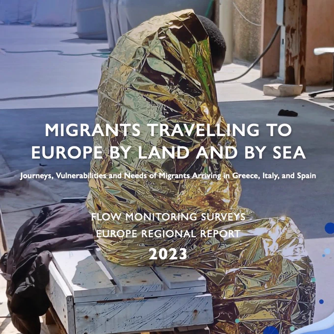 A person wrapped in a thermal blanket sits in a shelter. The image features the cover of an IOM report titled ‘Migrants Travelling to Europe by Land and by Sea’, with the subheading ‘Flow Monitoring Surveys, Europe Regional Report 2023.’