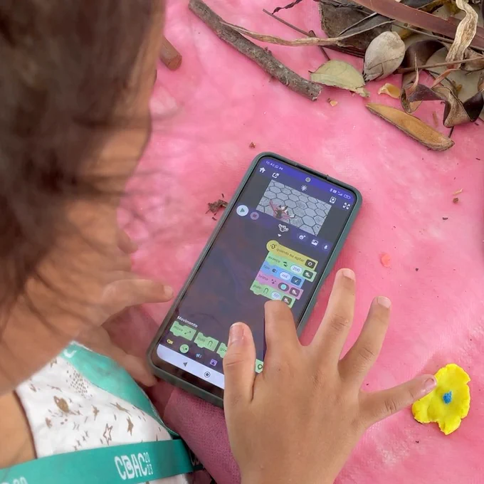 A young person is creating a project with OctoStudio. 