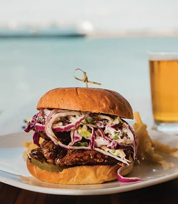 A photo of a Korean fried chicken sandwich from Bali Hai, a restaurant in San Diego
