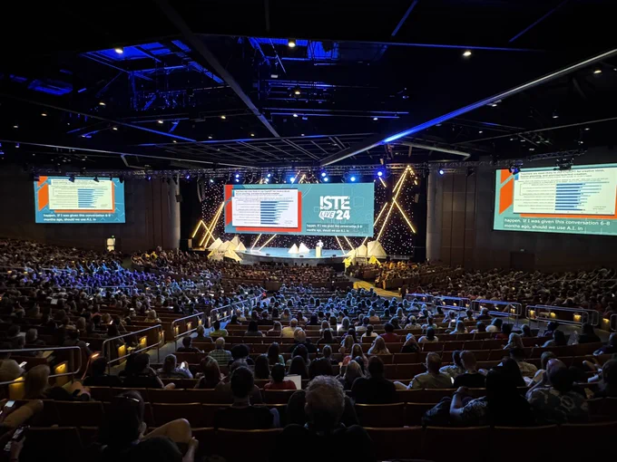 A large audience with a person on the stage