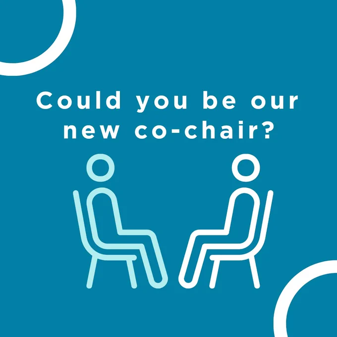 Blue square with white circles in top left and bottom right corners. Text in white "Could you be our new co-chair?" With outline of person sat in chair, mirrored with same image - on left in light blue, on right in white