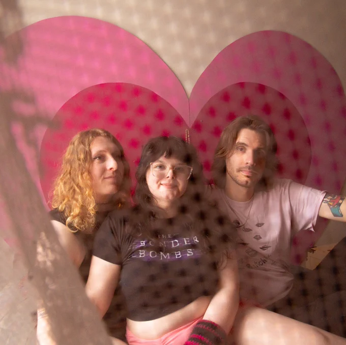 TSB promo photo!! Jer, Willow, Jimmy behind a lace curtain with a powerpuff style heart background <333
