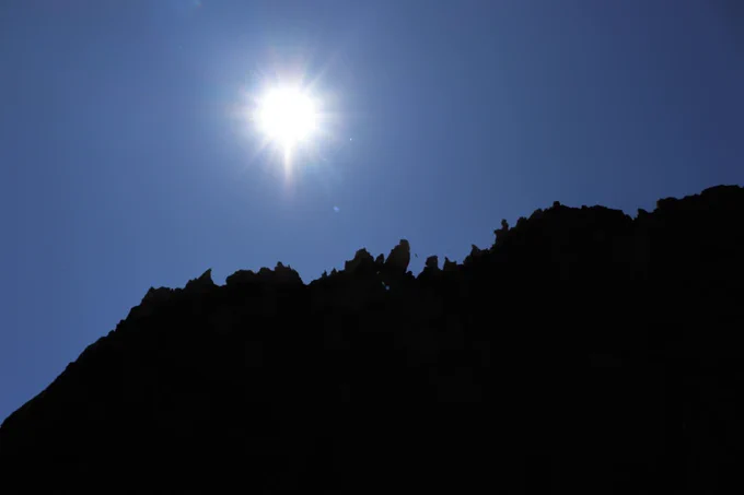 Smith rock state park rocks against blue sky and sun 