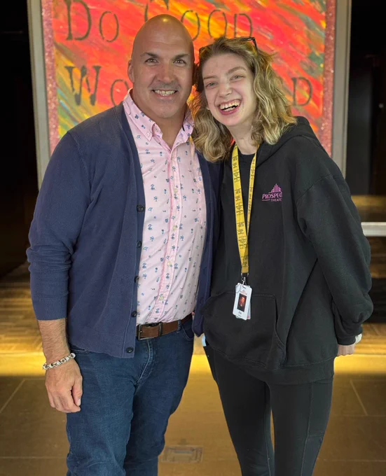Ali smiles with her former teacher, Mr. Dayton.