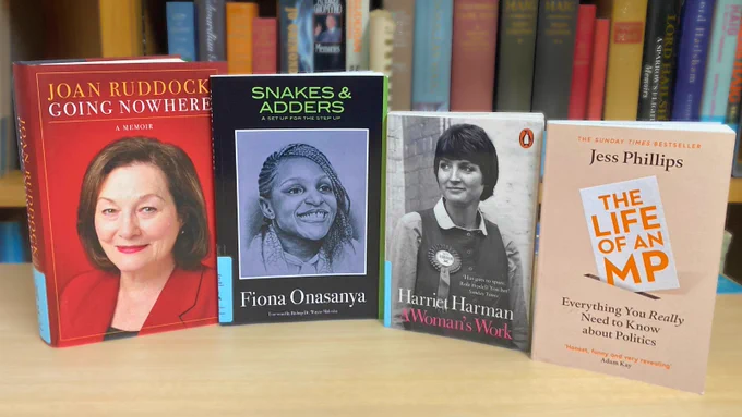 Four new books by female MPs standing upright on a desk with covers displayed. The memoirs and autobiographies of Joan Ruddock, Fiona Onasanya, Harriet Harman and Jess Phillips.