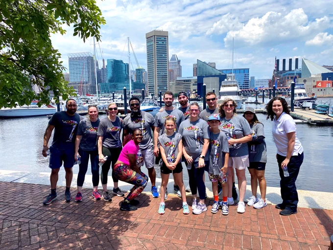District of Maryland personnel pose for a photo in front of the harbor. 