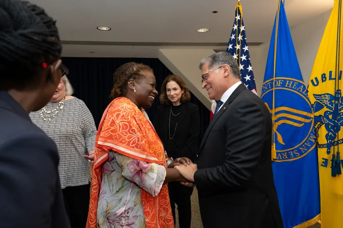 Secretary ecerra greeting woman 